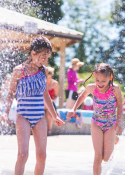 young girls playing at splashpad