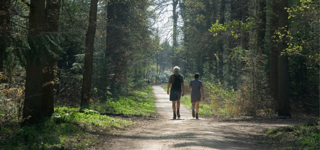 two people walking on nature path